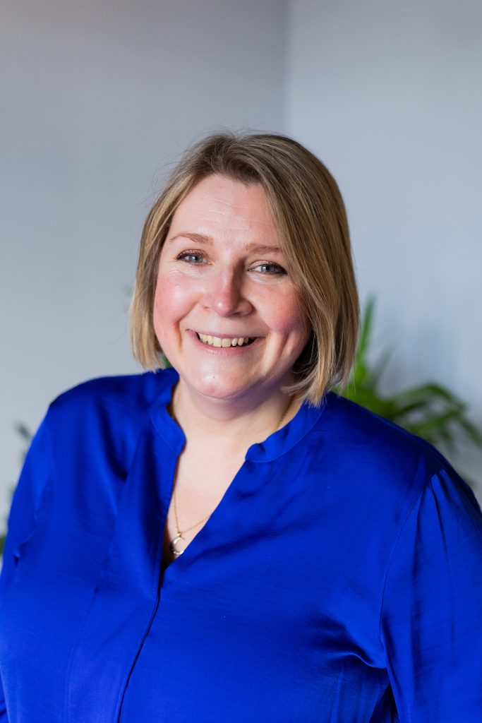Head and Shoulder Shot of Jacqui Kemp in Blue Shirt